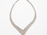 a picture of a silver necklace on a white background