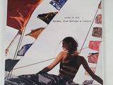 a picture of a woman sitting on a boat with flags