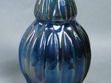 a blue vase that is sitting on a table