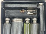 a box with a set of glass bottles and a bottle opener in it