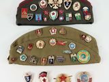 a lot of military badges on a hat