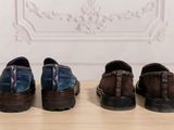 three pairs of shoes are lined up on a wooden table