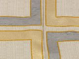a close up of a yellow and grey rug with squares on it