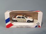 toy police car in a box on a gray surface