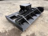 a close up of a skid steer on a dirt ground