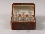 a small wooden box with a set of glasses inside of it