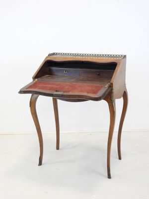 an old wooden desk with a drawer on top of it