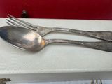 two forks and spoons sitting on a table