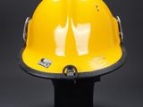a close up of a yellow hard hat on a black base