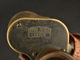 a close up of a metal object with a leather strap