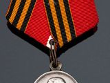 two medals and a medal on a table with a coin