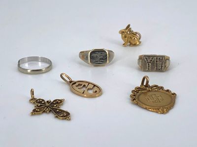 several different types of rings and pendants on a white surface