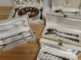 five silverware items in a case on a table