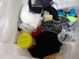 a white bag filled with clothes and other items