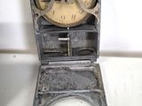 a small metal toilet with a clock on top of it
