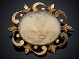 an image of a broochle with a flower design on it