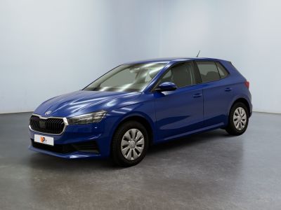 une voiture bleue garée dans une pièce aux murs blancs