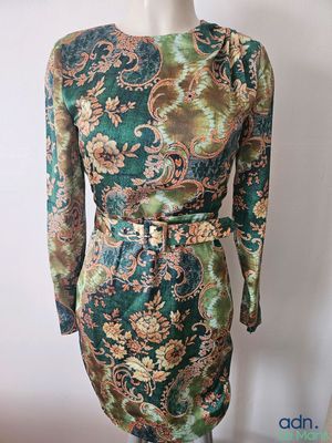 a mannequin mannequin dress with a green and gold floral print