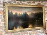 a painting hanging on a brick wall above a lamp