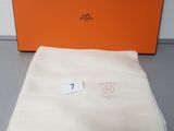 an orange box with a white blanket and a white towel