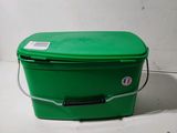 a green plastic box with a handle and a tag on it