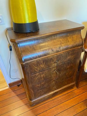 a wooden table with a lamp on top of it