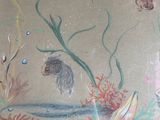 a drawing of a fish and other animals on the wall