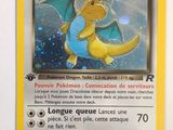 the pokemon card is yellow and has a blue dragon on it