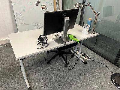 a desk with a computer and a monitor on it
