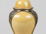 an image of a yellow vase sitting on top of a table