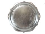 a silver plate that has a small hole in it