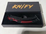 a knife in a black box with a red handle