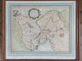 an old map of england in a frame hanging on a wall