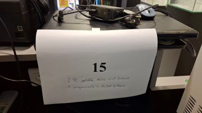 a sign on a desk that reads 15