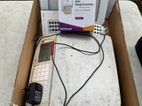 a box with a keyboard, mouse, and other electronic items in it