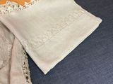 two napkins and a pillow on a bench