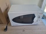 a microwave that is sitting on a table next to a box