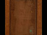 an old wooden picture frame with a green spot in the middle