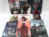 a lot of comic books on a white table
