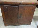 a small wooden cabinet with a drawer underneath it