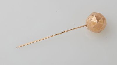 an image of a rose gold lapel pin on a white background