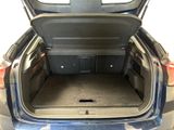 the back of a car with its trunk open and the back seats folded down