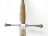 a silver and gold sword with a wooden handle