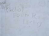 graffiti written on a concrete wall with a fire hydrant in the foreground