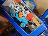 a person holding a toy truck in a blue box