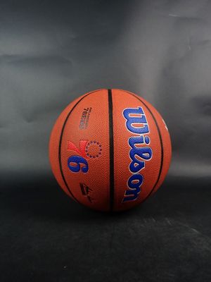 a close up of a basketball on a table with a gray background