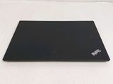 a black laptop sitting on a white surface with a white background
