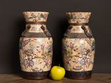 two vases sitting next to each other on a table
