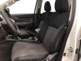 the interior of a small car with black seats and a steering wheel