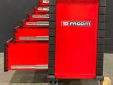 a lot of red tool boxes that are on a cart
